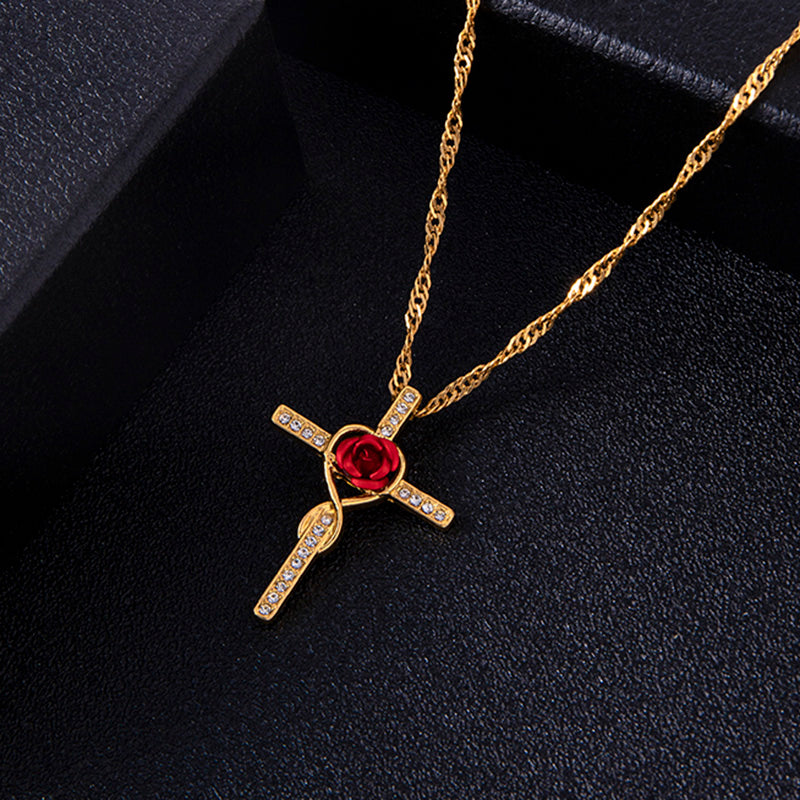 Gold necklace with a red gemstone pendant on a black background