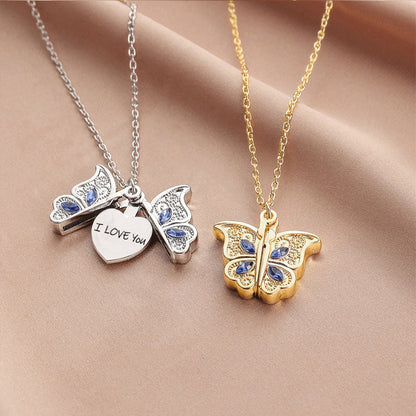 Butterfly-shaped necklaces with 'I LOVE YOU' heart pendant on a beige fabric background
