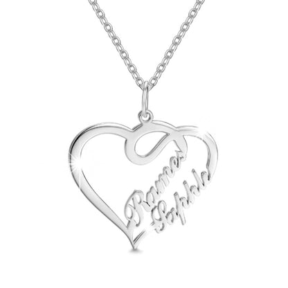 Silver heart-shaped necklace with engraved names on a white background